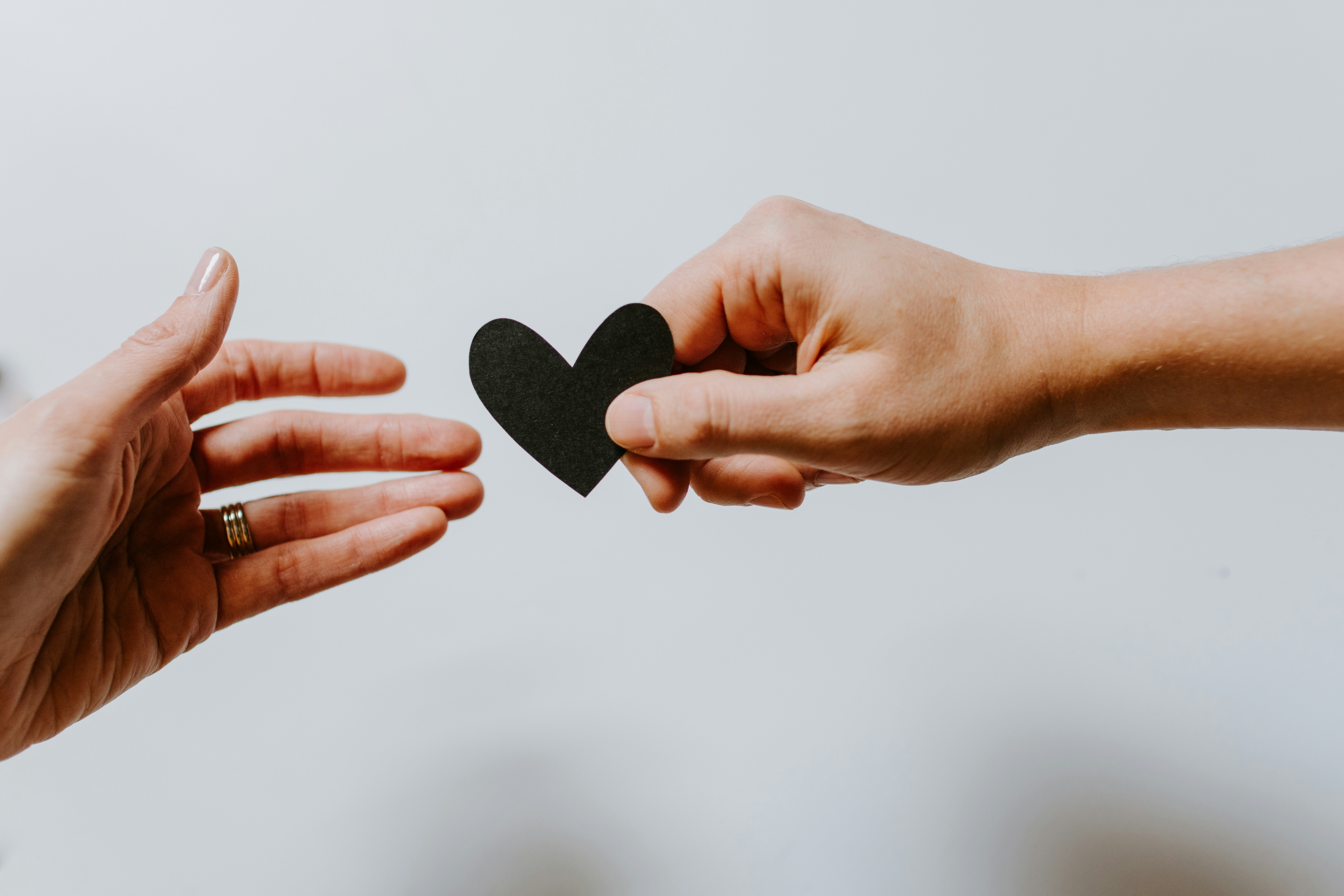 Two hands sharing a heart
